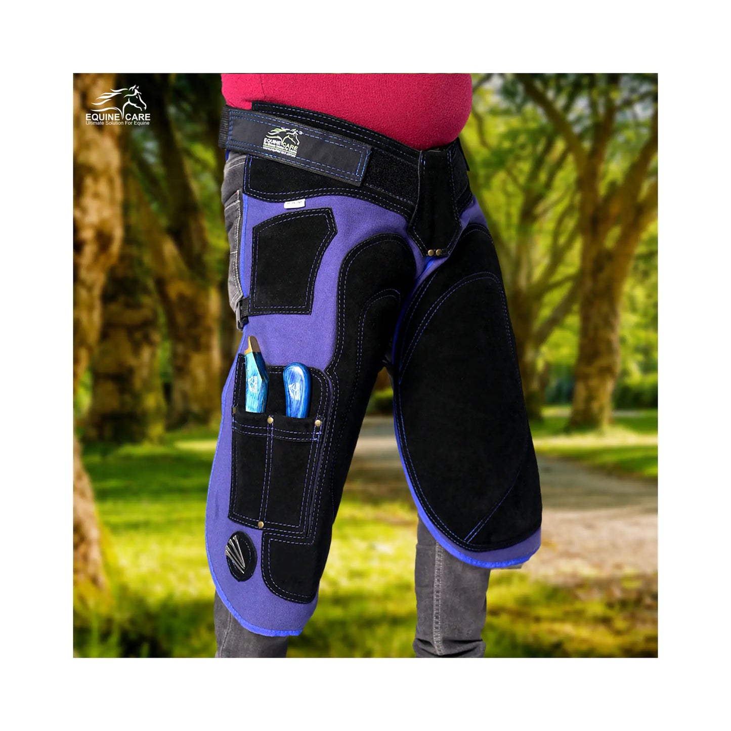 Black-and-Blue Azure Armor Farrier Apron Farrier wearing black and blue professional chaps with reinforced thigh padding and integrated tool pockets, shown outdoors during horse shoeing and hoof care work