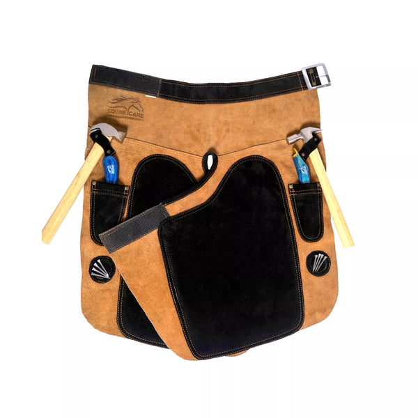 Front view of 25-inch Premium Elite Farrier Apron featuring tan leather construction, black reinforced thigh pad, adjustable waist belt, dual hammer loops, and tool pockets for professional horse shoeing and farrier work