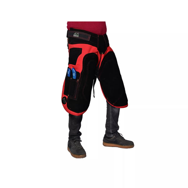 Side view of Crimson Shield Farrier Apron worn by a farrier, showing red and black reinforced thigh padding, adjustable waist belt, and integrated tool pockets for professional horse shoeing work