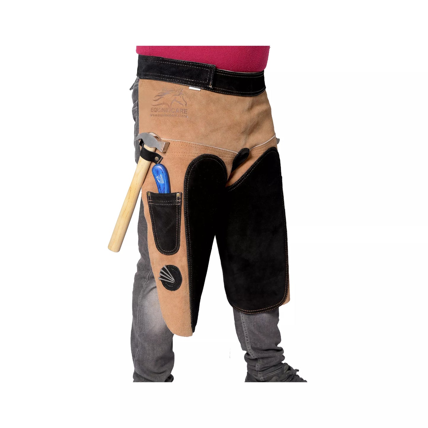 Side view of 25-inch Premium Elite Farrier Apron worn by a farrier, showing tan leather construction, black reinforced thigh pad, hammer loop, and integrated tool pocket for professional horse shoeing work