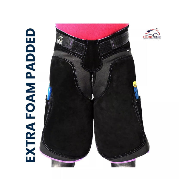 A durable women’s farrier apron made from suede leather with foam padding and tool pockets for hoof trimming Black with purple Piping